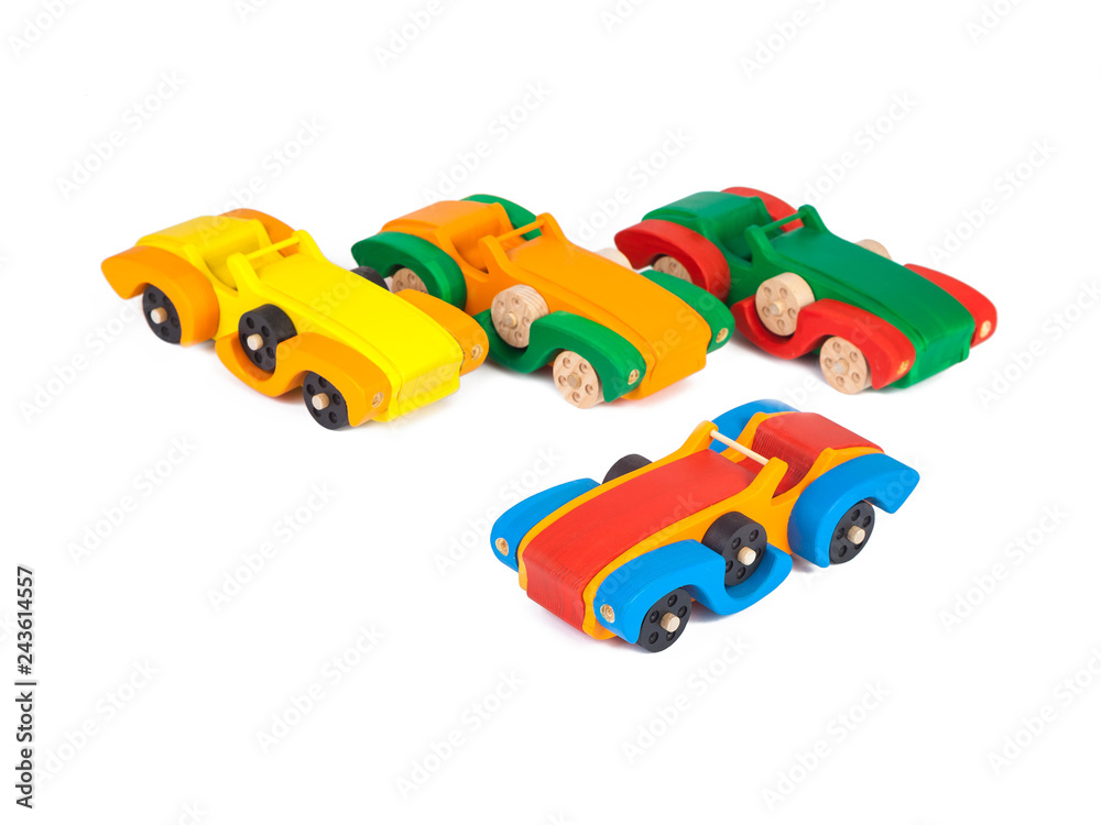 Photo of the a retro cars cabriolets of beech in different colors . Toys made of wood on a white isolated background Photo of the a retro cars cabriolets of beech in different colors . Toys made of wood on a white isolated background