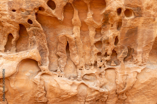 Cairns placed in a weathered wall of sandstone in Devils Garden Trail in Arches National Park, Utah