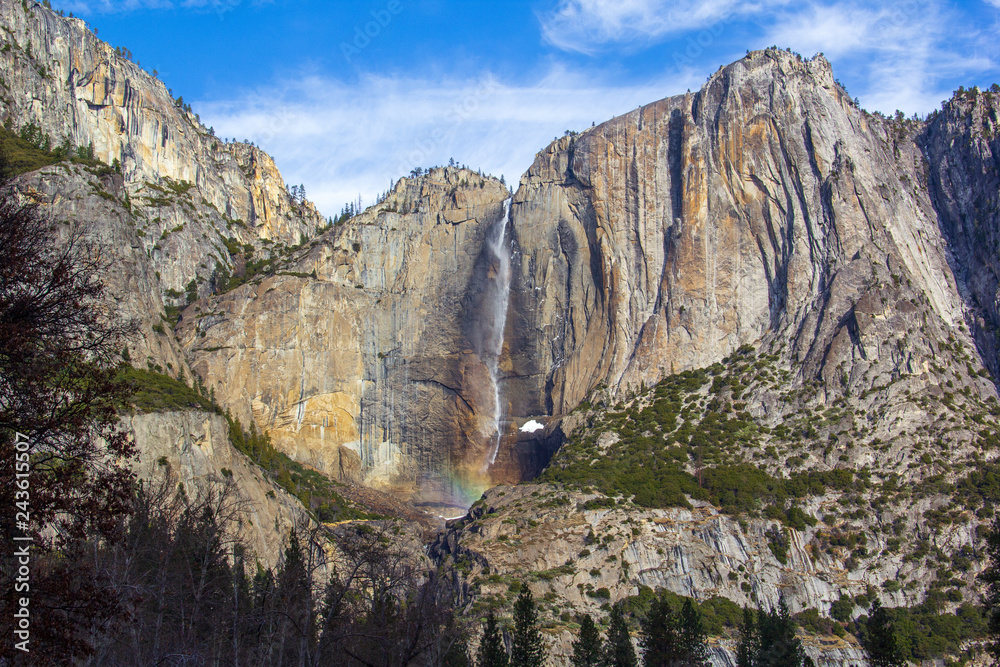 Yosemite fall with a rainbow on its bottom seen from Yosemite's central valley