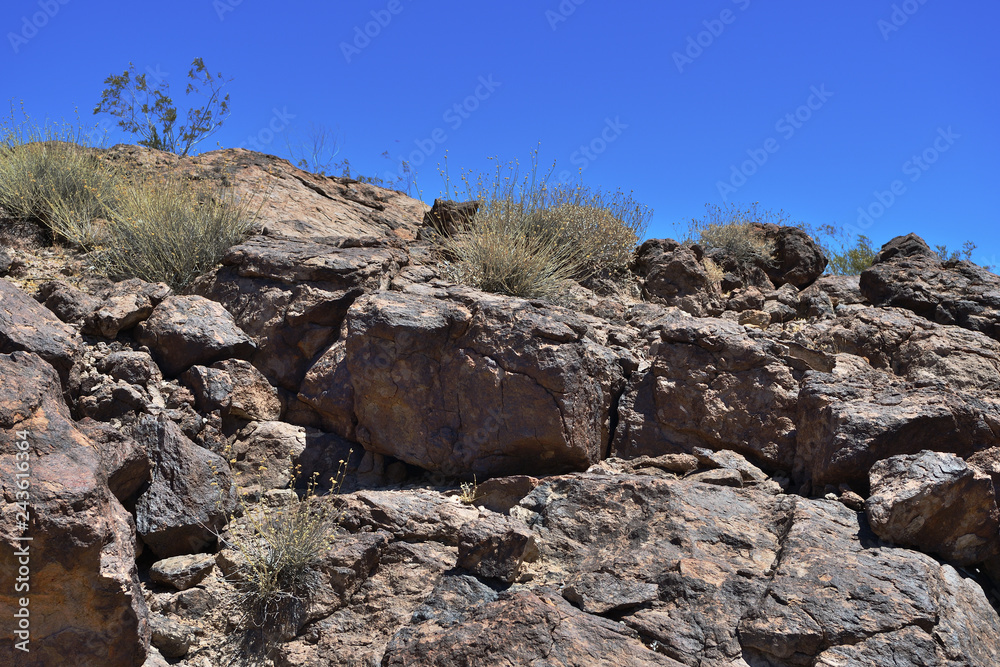 Fragment of rock against the blue sky as texture and background