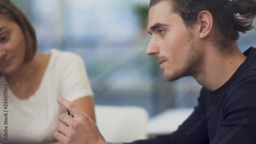Young man talking about the development of the company entrepreneur on negotiation in meeting room Young man talking about the development of the company entrepreneur on negotiation in meeting room