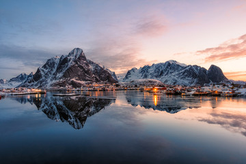 Fishing village with snow mountain at sunrise