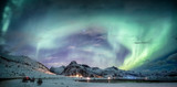 Northern lights explosion on snowy mountain range