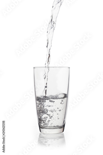 Water falling in glass on isolate background.