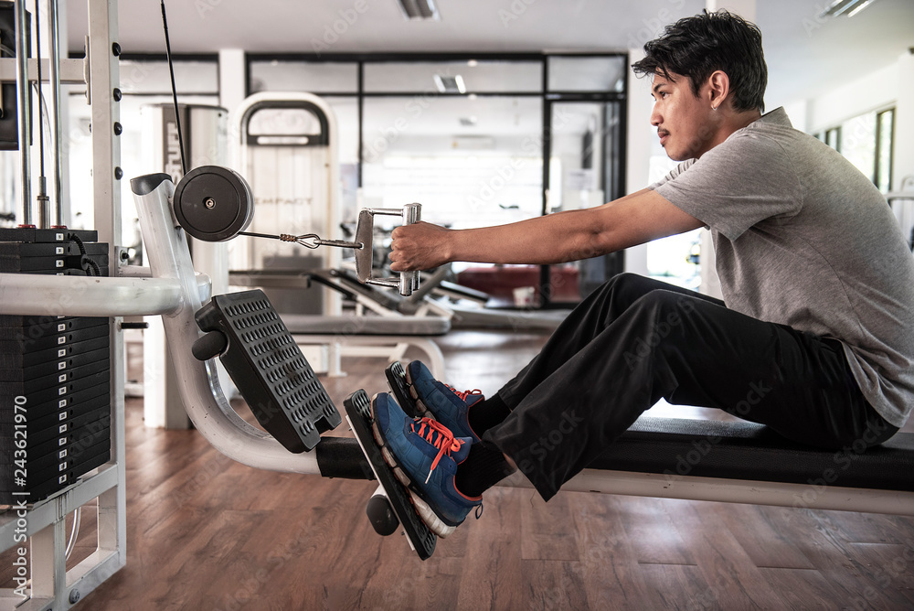 sporty man exercising on pull down weight machine in gym. Concept workout  healthy lifestyle sport. exercises hand pulling the block. - Image Stock  Photo | Adobe Stock