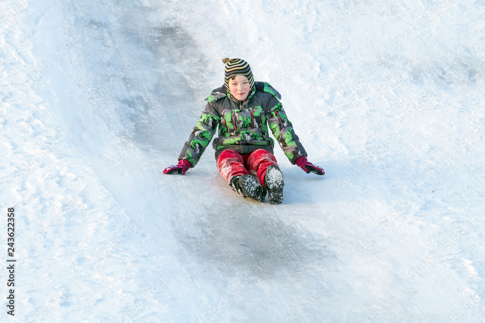 Happy boy with snow tube