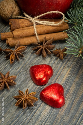Fototapeta Naklejka Na Ścianę i Meble -  Christmas concept with spices nuts and red apple