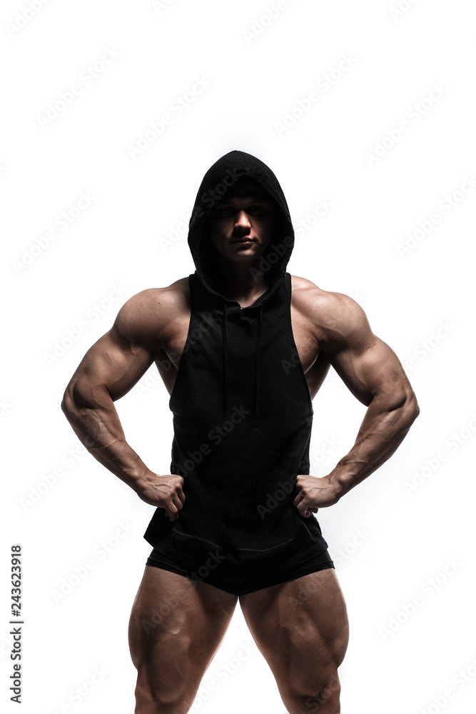Handsome power athletic man pumping up muscles in anonymous hoodie