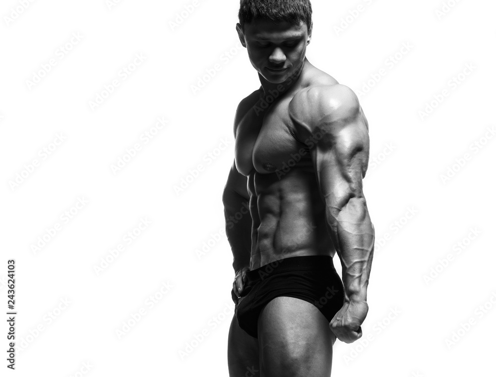 Handsome power athletic man pumping up muscles isolated over white. Strong bodybuilder with perfect shape body and six pack, abs, shoulders, biceps, triceps and chest. Handsome power athletic man pumping up muscles isolated over white. Strong bodybuilder with perfect shape body and six pack, abs, shoulders, biceps, triceps and chest.