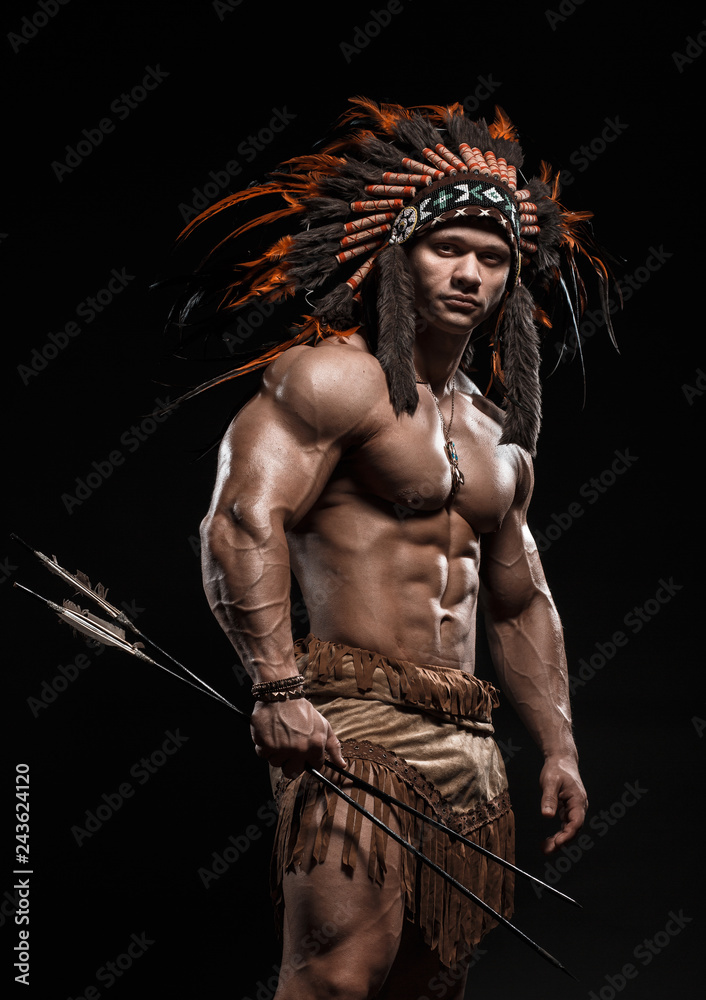 American Indian Apache Warrior Chief In Traditional Clothing And Feathered Headdress With Weapon