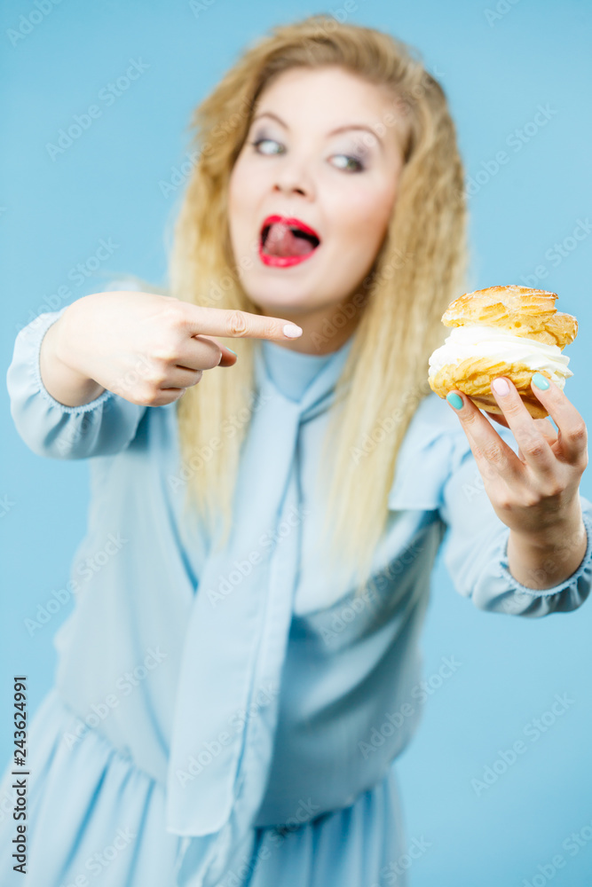 Funny woman holds cream puff cake Funny woman holds cream puff cake