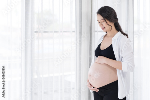 pregnant woman looking her belly with window background Free Download pregnant woman looking her belly with window background - GFXLoad
