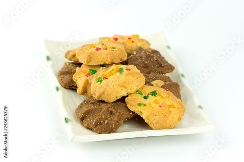 Many variety homemade cookies in plate isolated on white background.