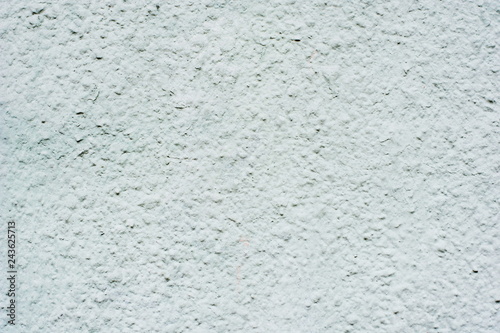 Background of a blue stucco coated and painted exterior, rough cast of cement and concrete wall texture