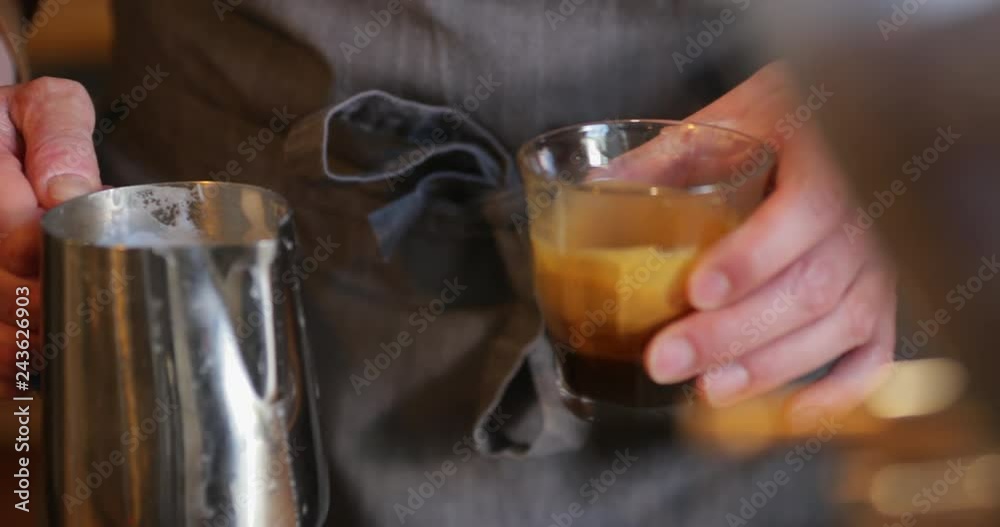 Barista Pouring Milk into a Latte