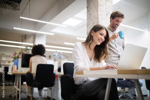Cheerful coworkers in office during company meeting © NDABCREATIVITY