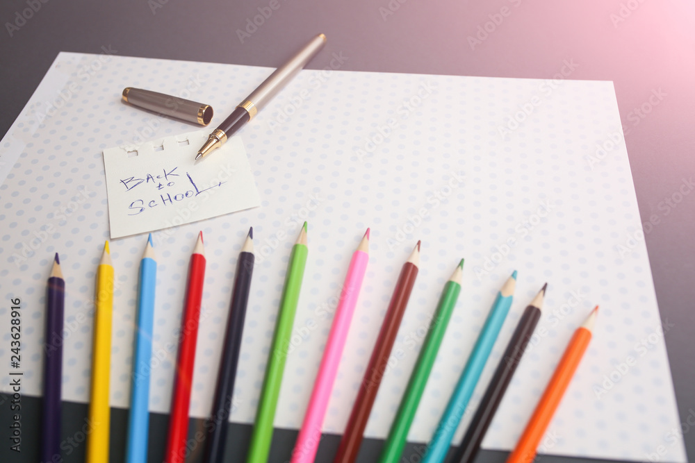 Color pencils lying on cute spotted background with dots. Back to school concept and sign written with a pen. Colorful art studying and painting process. Copy space place for postcard wish. Color pencils lying on cute spotted background with dots. Back to school concept and sign written with a pen. Colorful art studying and painting process. Copy space place for postcard wish.