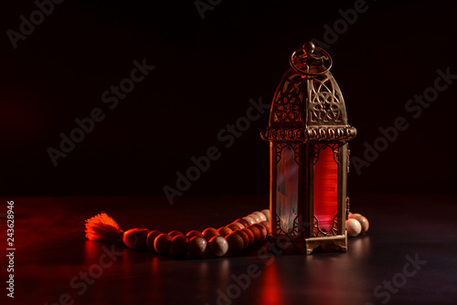Muslim lamp as Ramadan symbol and tasbih on dark background photo