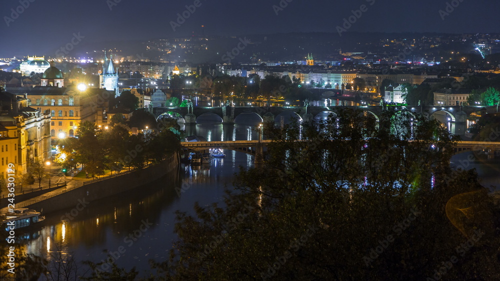 Aerial night view of the Vltava River and illuminated bridges timelapse, Prague