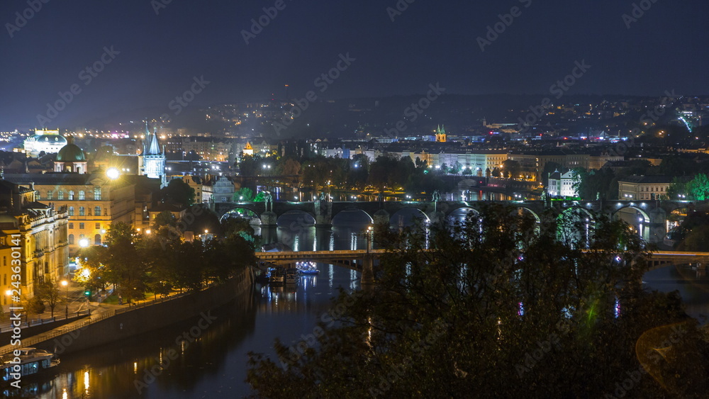 Aerial night view of the Vltava River and illuminated bridges timelapse, Prague