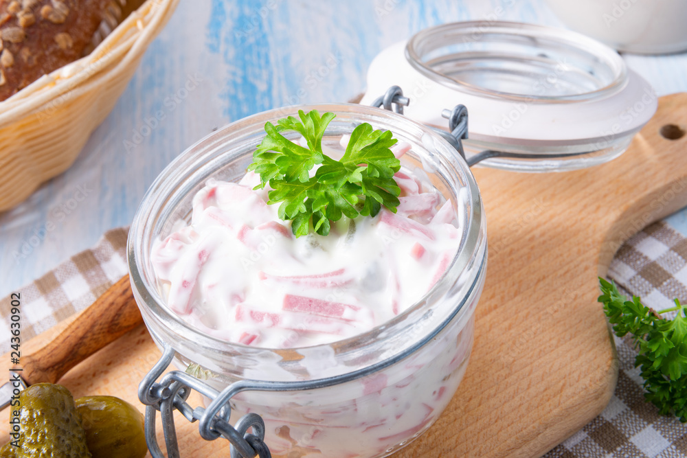 delicious homemade meat salad with mayonnaise and cucumber