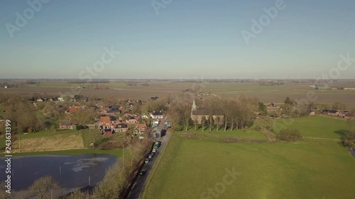Aerial drone shot from the Andreas Church located on a mound in the center of Westeremden, The Netherlands. photo