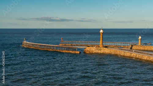 The Whitby harbour and pier in North Yorkshire, England, UK - seen from the East Terrace