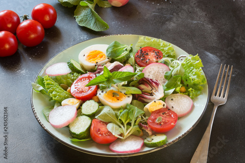 Clean eating. Healthy salad with vegetables and eggs on black. Balanced diet for weight loss.