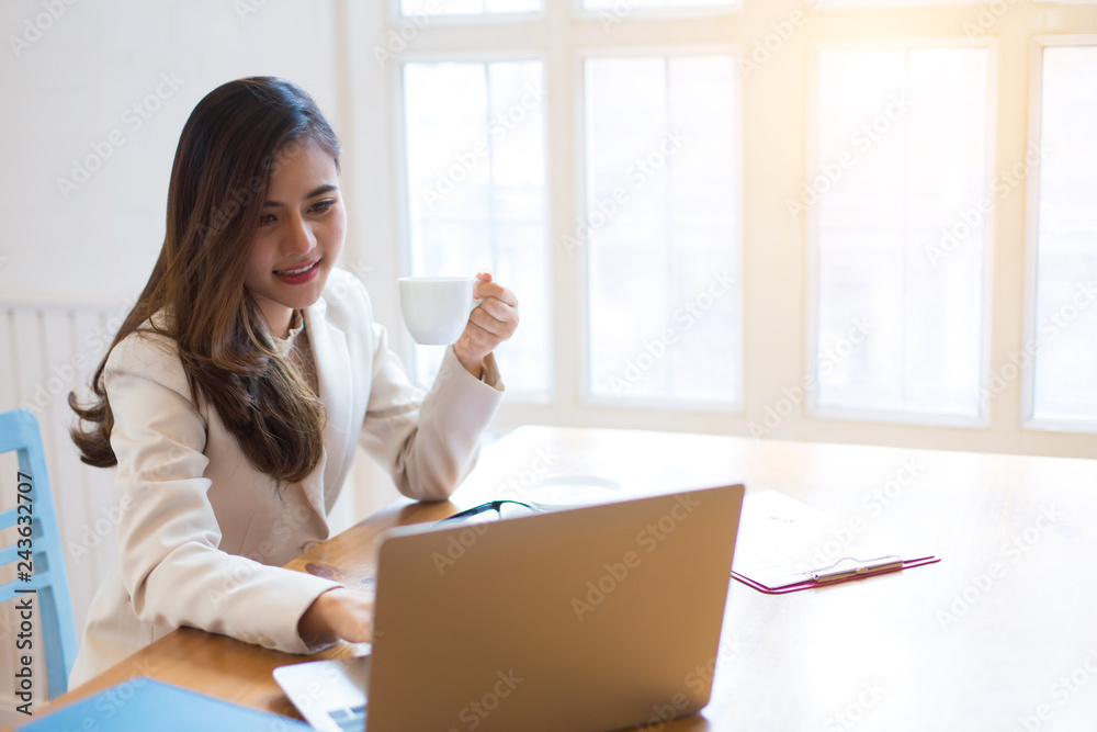 Protrait of Beautiful businesswoman sitting at desk and working with laptop computer. Protrait of Beautiful businesswoman sitting at desk and working with laptop computer.
