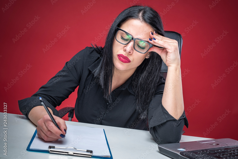 Overworked young business woman working late, having a bad headache Overworked young business woman working late, having a bad headache
