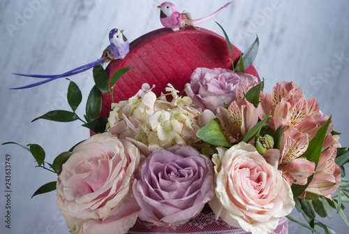 bouqet of flowers in redt box. Nice celebration present. Selective focus, close up. Birds of top bouqet photo