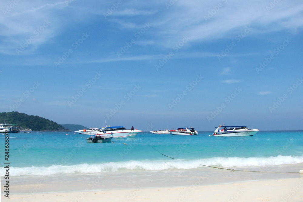 Princess Bay in the Similan Islands, view from the shore. Tourist boats on the blue clear waters of a bay. Princess Bay in the Similan Islands, view from the shore. Tourist boats on the blue clear waters of a bay.