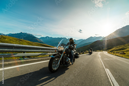 Motorcycle driver riding in Alpine highway, Hochalpenstrasse, Austria, Europe.