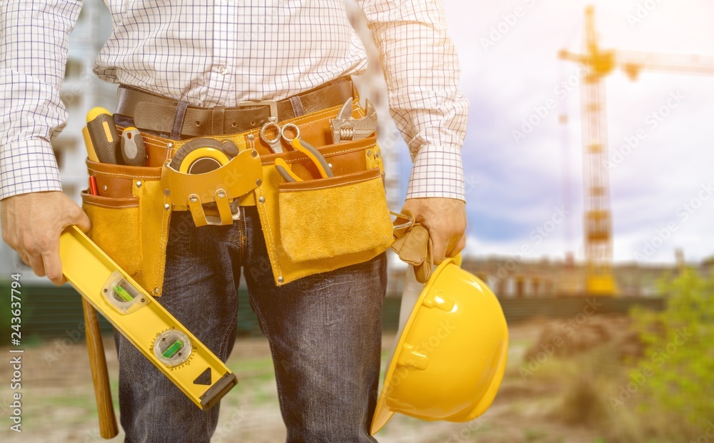 Worker with a tool belt. Isolated over background. Worker with a tool belt. Isolated over background.