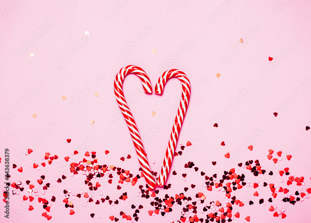 Valentine's day background. Little red hearts on pink background with shining lights bokeh.