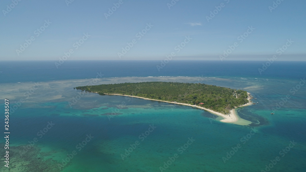 Tropical island with white sandy beach. Aerial view: Magalawa island with colorful reef. Seascape, ocean and beautiful beach paradise. Philippines,Luzon. Travel concept.