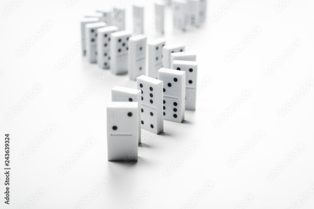 selective focus of domino row isolated on white with copy space selective focus of domino row isolated on white with copy space