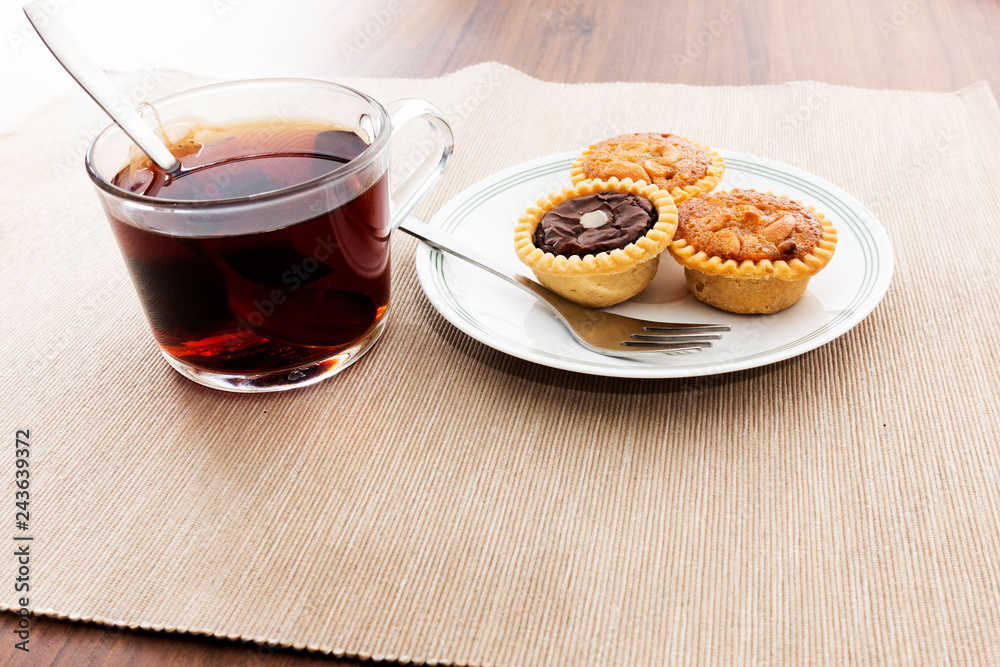 Tea time with hot tea and dessert tarts Tea time with hot tea and dessert tarts