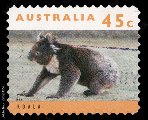 Stamp printed in Australia shows a koala bear sitting on grassy ground, circa 1994.