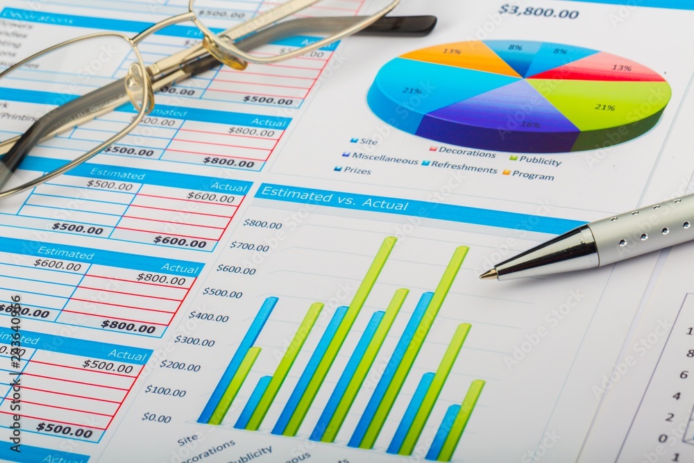 Pen and Eyeglasses on Business Graphs and Charts Pen and Eyeglasses on Business Graphs and Charts