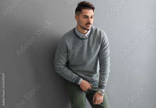 Stylish handsome man on grey background