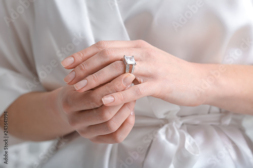 Beautiful young woman with stylish ring, closeup