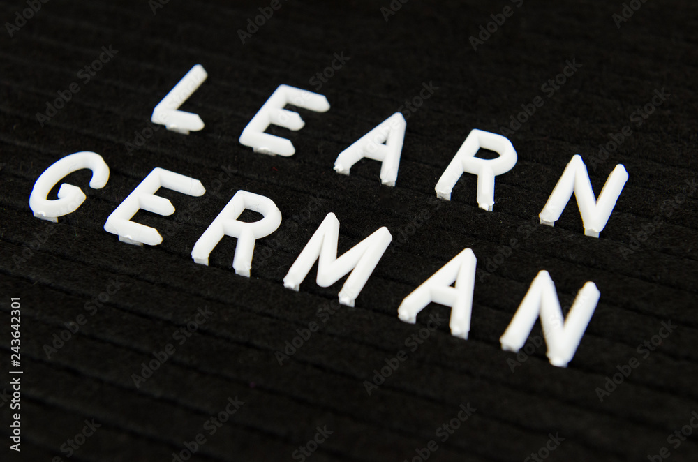 Fototapeta premium Learn German, GER abbreviation, simple sign on black background, great for teachers, schools, students
