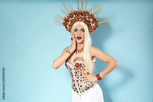 Fotografie Portrait of emotional transgender man in bright costume on color background