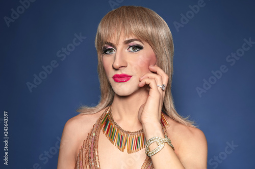Portrait of young transgender man on color background photo