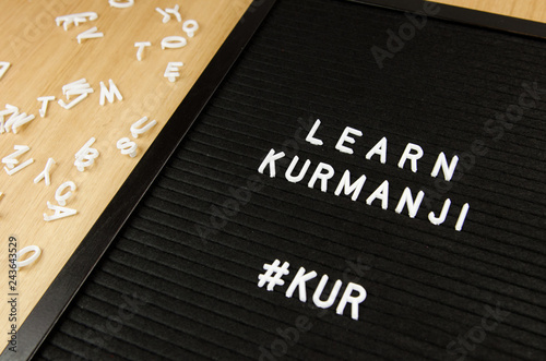 Learn Northern Kurdish Kurmanji language, KUR abbreviation, simple sign on black background, great for teachers, schools, students photo