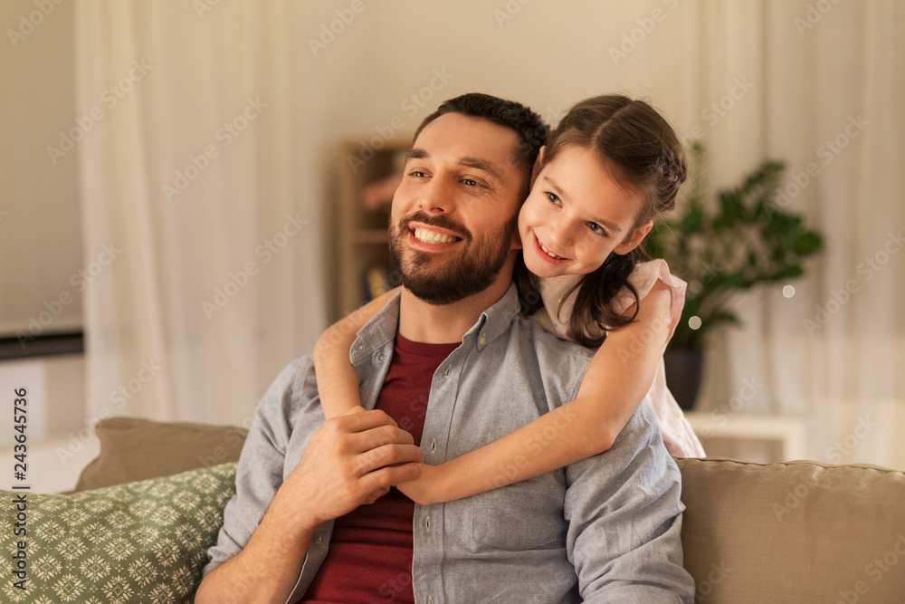 Fototapeta premium family, fatherhood, leisure and people concept - happy smiling father and little daughter hugging at home