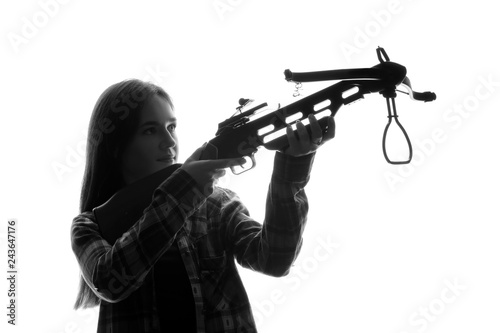 Schilderij op canvas Silhouette of young woman with crossbow on white background