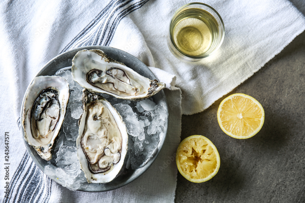 Plate with tasty cold oysters on table Plate with tasty cold oysters on table
