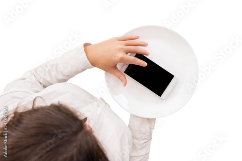 Mobile phone served on empty serving plate. Top view of a waitress in a white blouse on the white background. Concept. Isolated